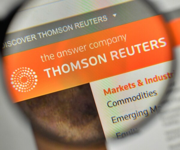 thomson reuters logo on the website homepage through magnifying glass. 