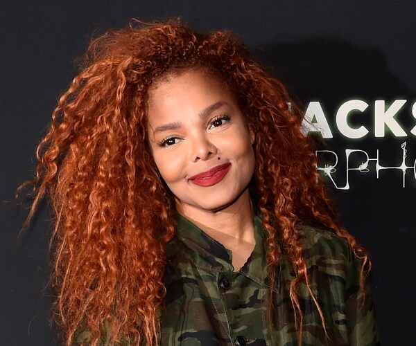 janet jackson stands on red carpet