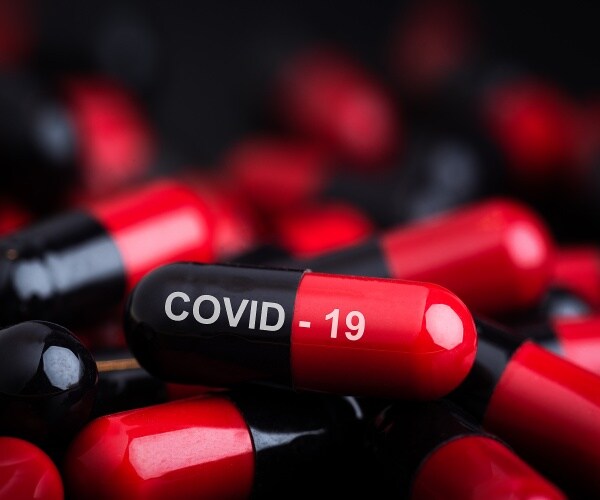 red and black capsules, one labeled COVID-19