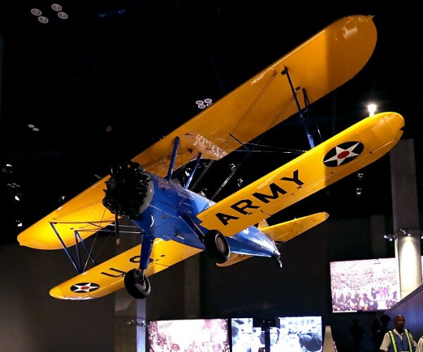 the plane is suspended from a ceiling in a museum display