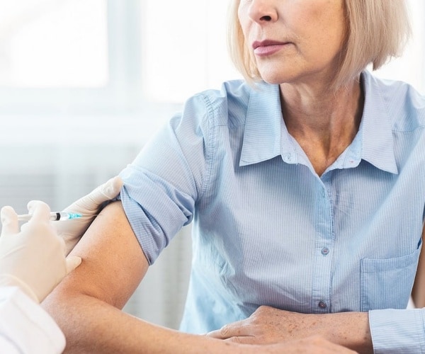 person getting a shot in arm