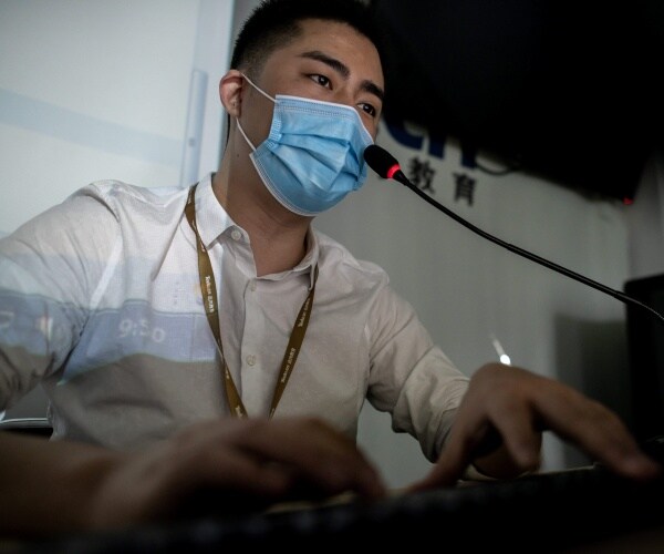 A tutor teaches an online coding class.