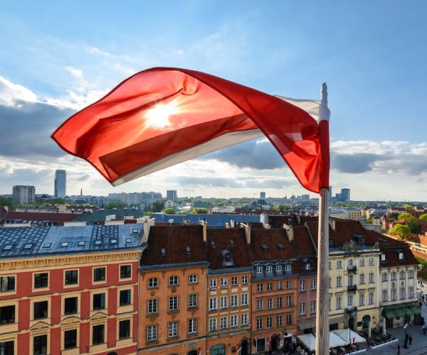 the polish flag flying over warsaw
