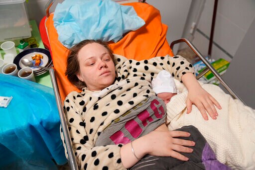 Amid Mariupol Horror, a Newborn Rests in Her Mother's Arms
