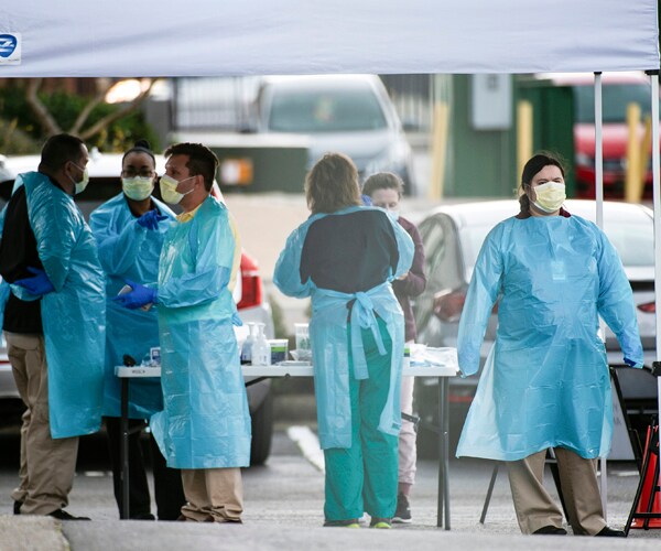 a medical team at a drive-through coronavirus testing clinic in huntsville, alabama