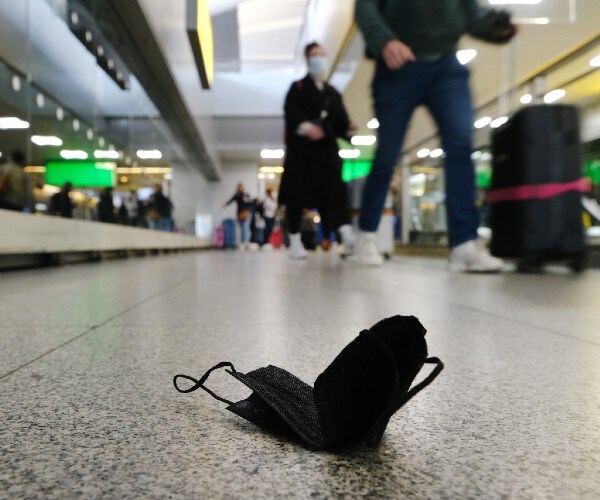 a mask lying on an airport terminal floor.