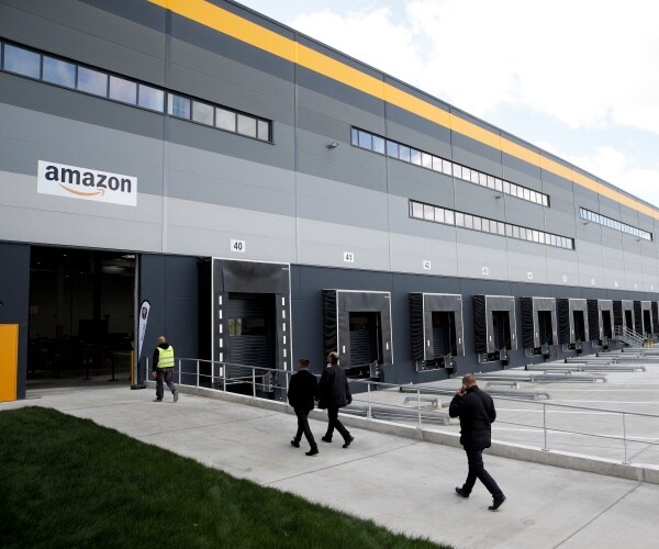 amazon factory is shown with workers walking in