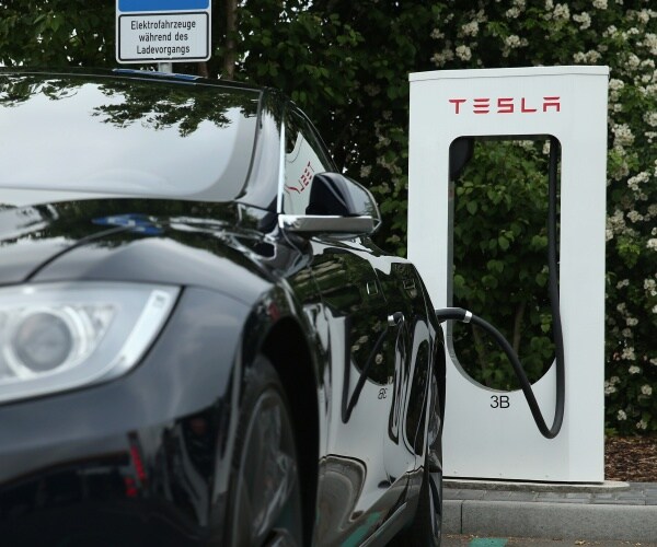 black tesla car at a charging station