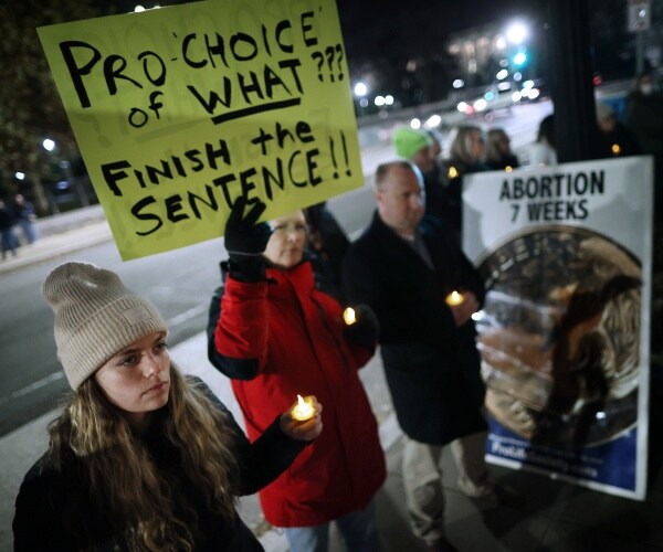 Anti-abortion activists hold a candlelight vigil