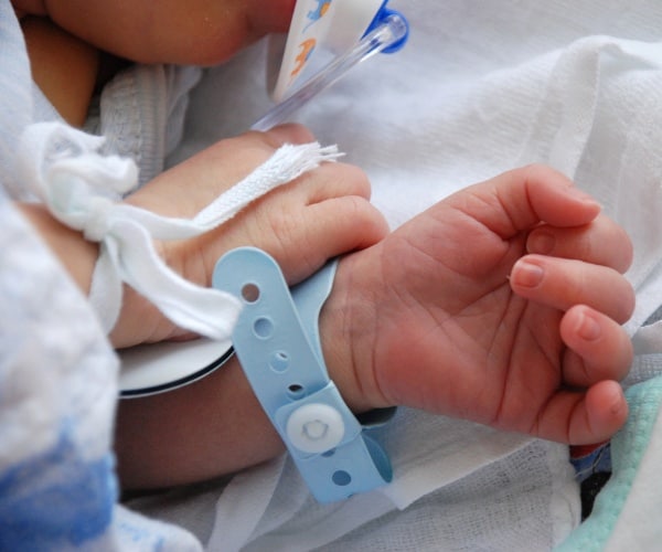 close up of newborn baby's hands in hospital