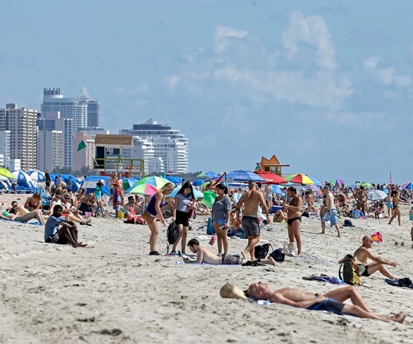 Local residents and tourists enjoy a day at the beach in the South Beach area of Miami Beach, Fla.  