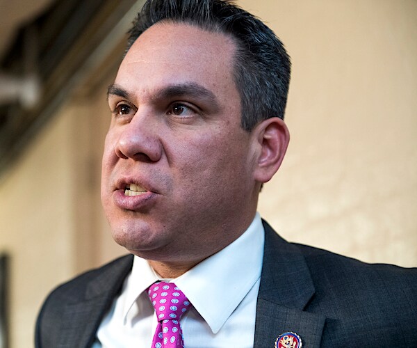 california democratic representative pete aguilar looks to his left and makes remarks to reporters