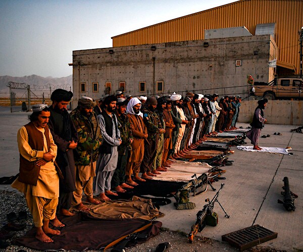 taliban troops line up at the airport after the takeover