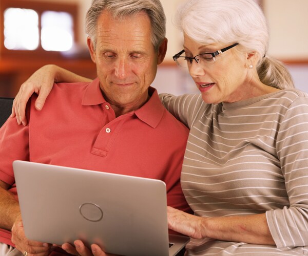 senior citizens looking on a computer
