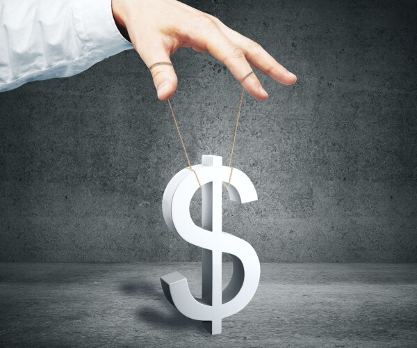 a hand controlling dollar sign as puppet 
