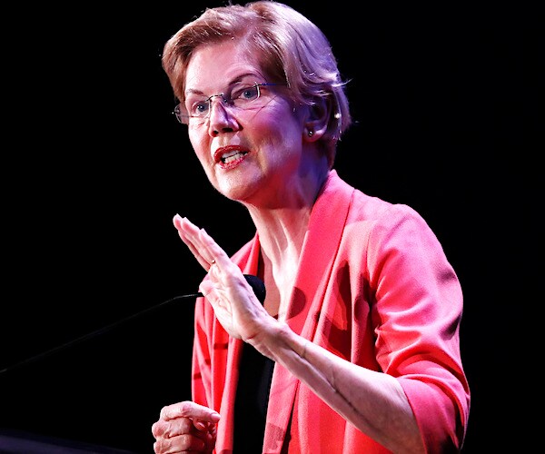 elizabeth warren gestures as she speaks to a crowd during a town hall