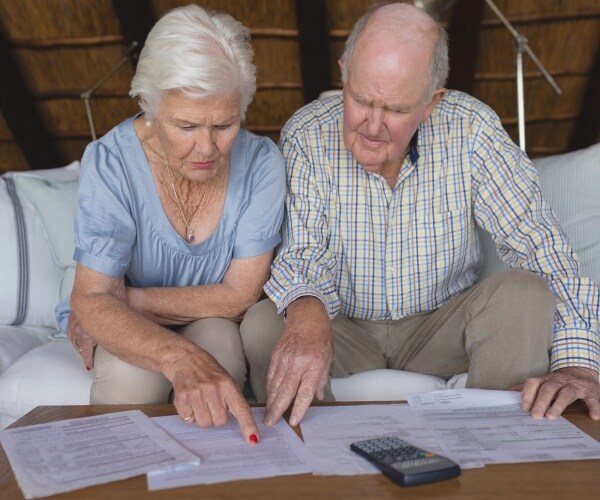 older couple looking at a variety of medical bills