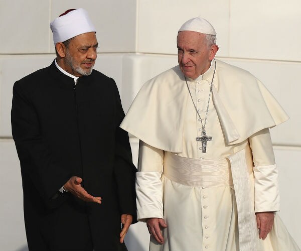 Doctor Ahmed Al Tayeb gestures to Pope Francis