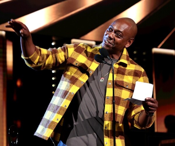 Dave Chappelle speaks onstage
