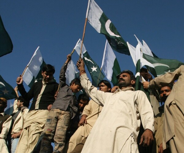pakistani traders wave flags