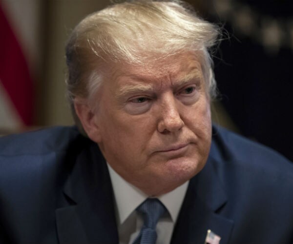 president donald trump is seen at the white house, in blue suit, dress shirt and blue tie