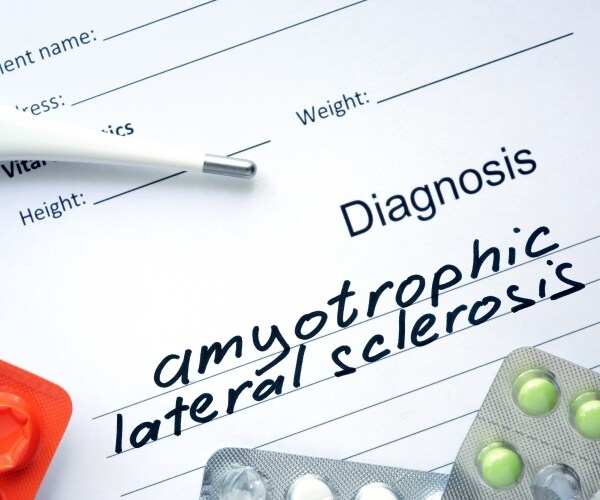 doctor's pad that says diagnosis amyotrophic lateral sclerosis, some pills, thermometer