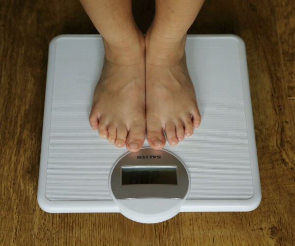 a person's feet on bathroom scales
