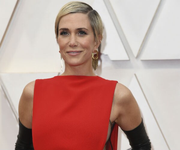 kristen wiig is shown in a red dress