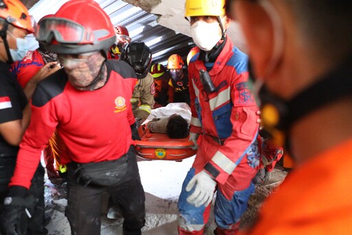Rescuers Chip Away Debris with Hand Tools to Save Those Trapped in Indonesia School Collapse