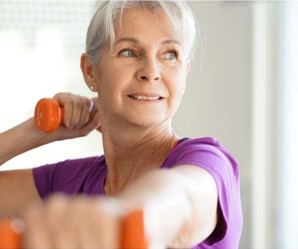 older woman working out with light hand weights