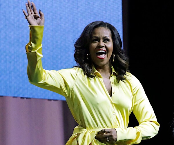 michelle obama smiles wide and waves before delivering a democratic national convention speech