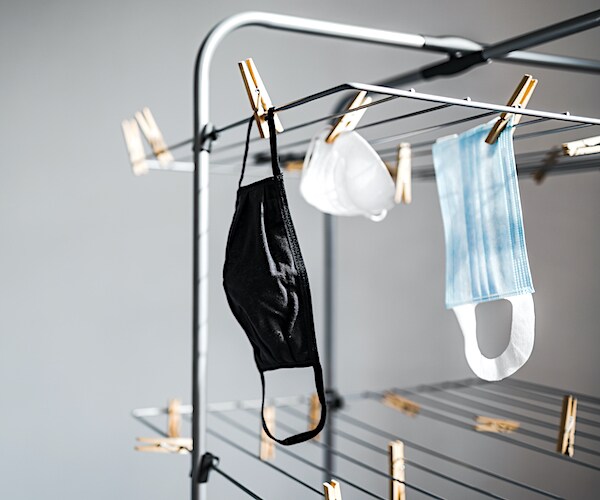 face masks are hung out to dry on a shelf
