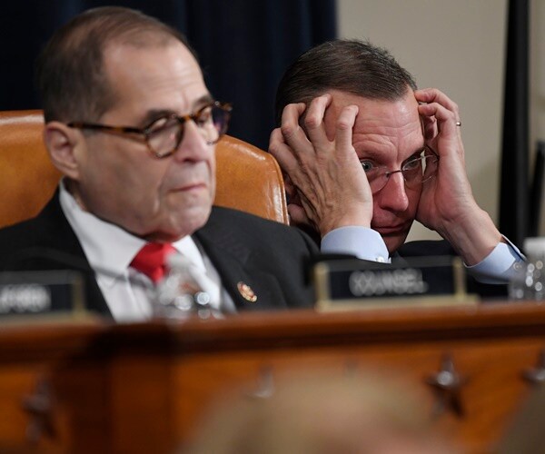 rep. doug collins holds his head listening to testimony next to rep. jerrold nadler