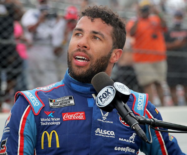 nascar's bubba wallace is shown during an interview in his racing gear