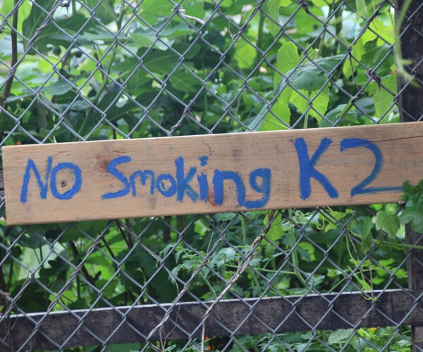 A sign hangs on a fence in Brooklyn, New York