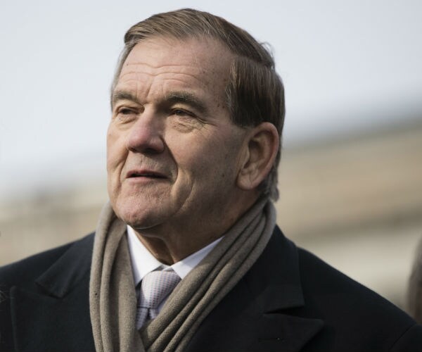 former homeland security secretary tom ridge is shown in an overcoat with a brown scarf