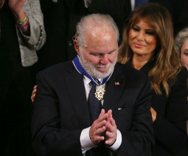 rush limbaugh is shown with melania trump in background