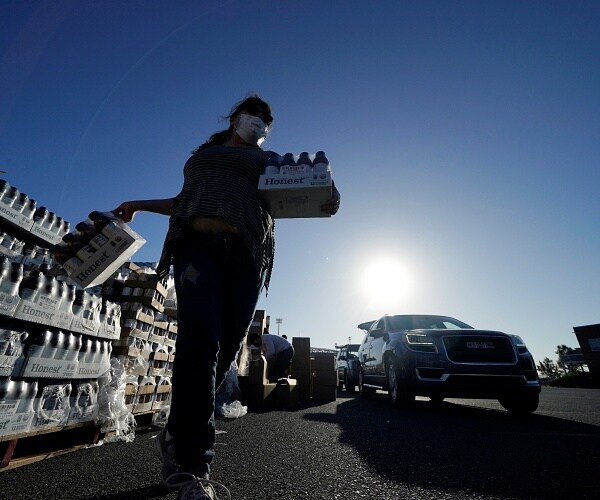volunteers hand out food to people