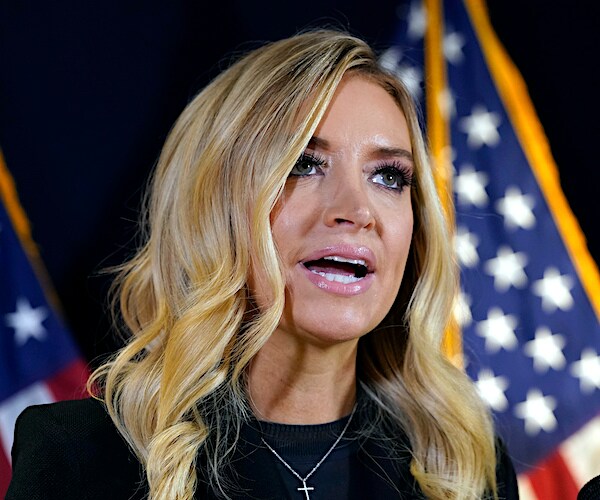 kayleigh mcenany speaks during a news conference in front of an american flag