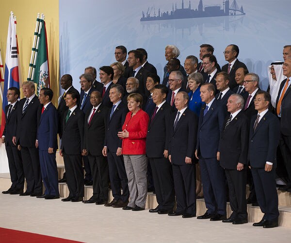 France's Macron Leaves G-20 Group Photo Spot to Stand With Trump