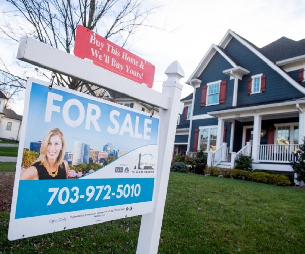 A for sale sign is seen in a yard