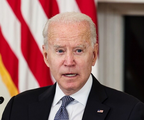 joe biden sits at table