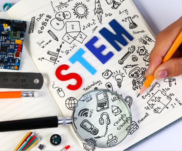 the letters s t e m on graph paper with drawings of various subjects and a hand with a pencil