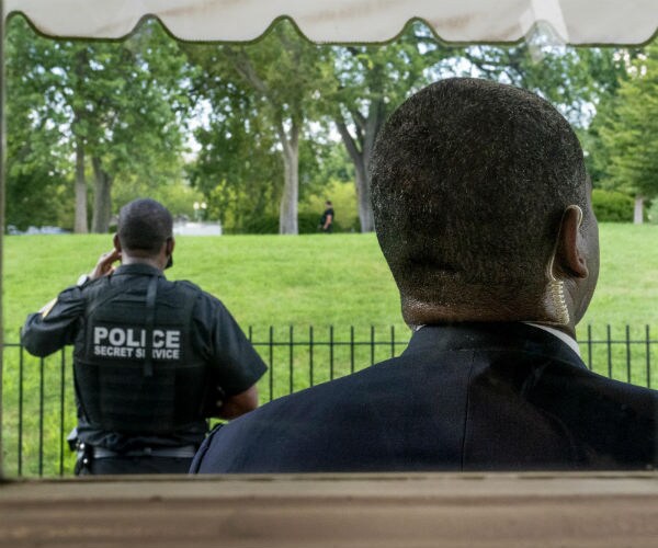 secret service agents stand guard at the white house