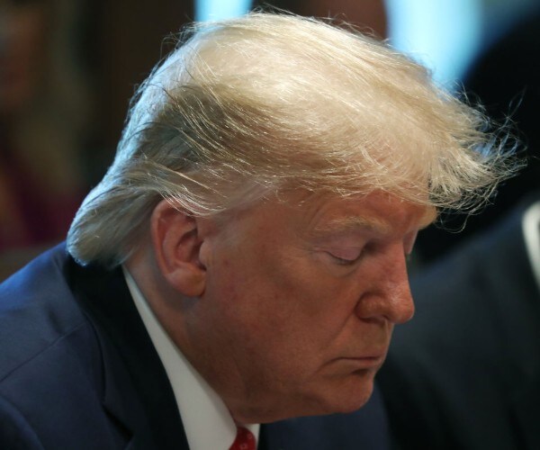 President Donald Trump pauses while outgoing Energy Secretary Rick Perry reads a prayer