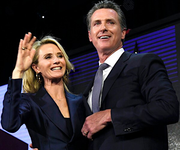 Jennifer and Gov. Gavin Newsom smile after their election victory