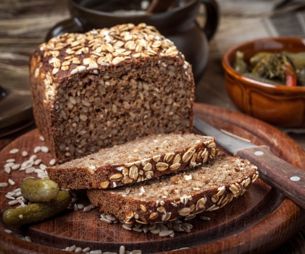 a loaf of sliced bread with seeds