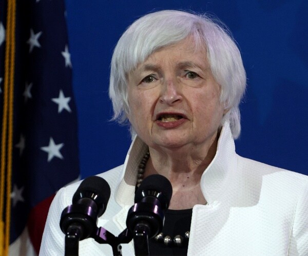 janet yellen speaks into microphone