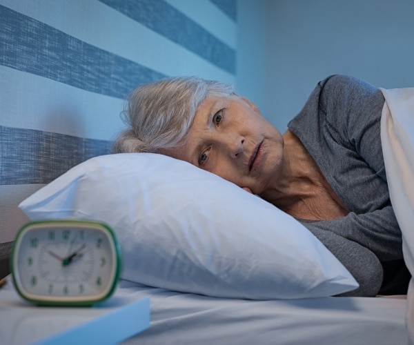 anxious woman awake at night 