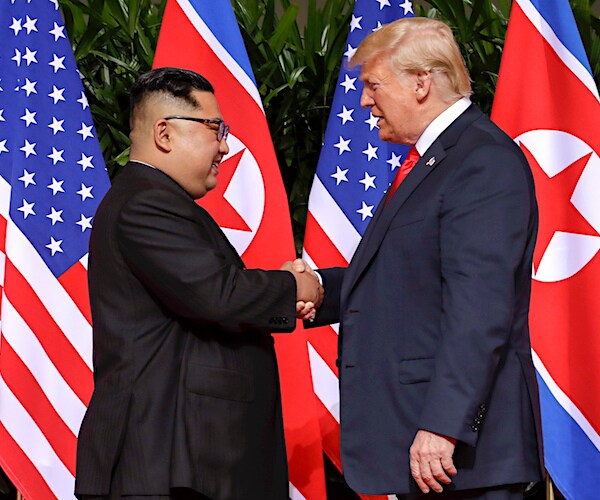 kim jong un shakes the hand of president donald trump during their first summit last year